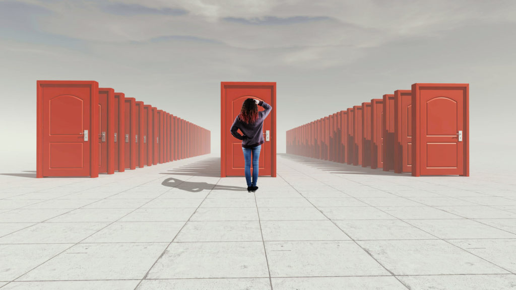 Young woman standing in front of many doors, symbolic of considering alternatives to college